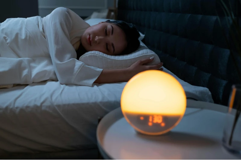 A woman sleeping on her side, looking completely peaceful: Best Cannabis for Sleep