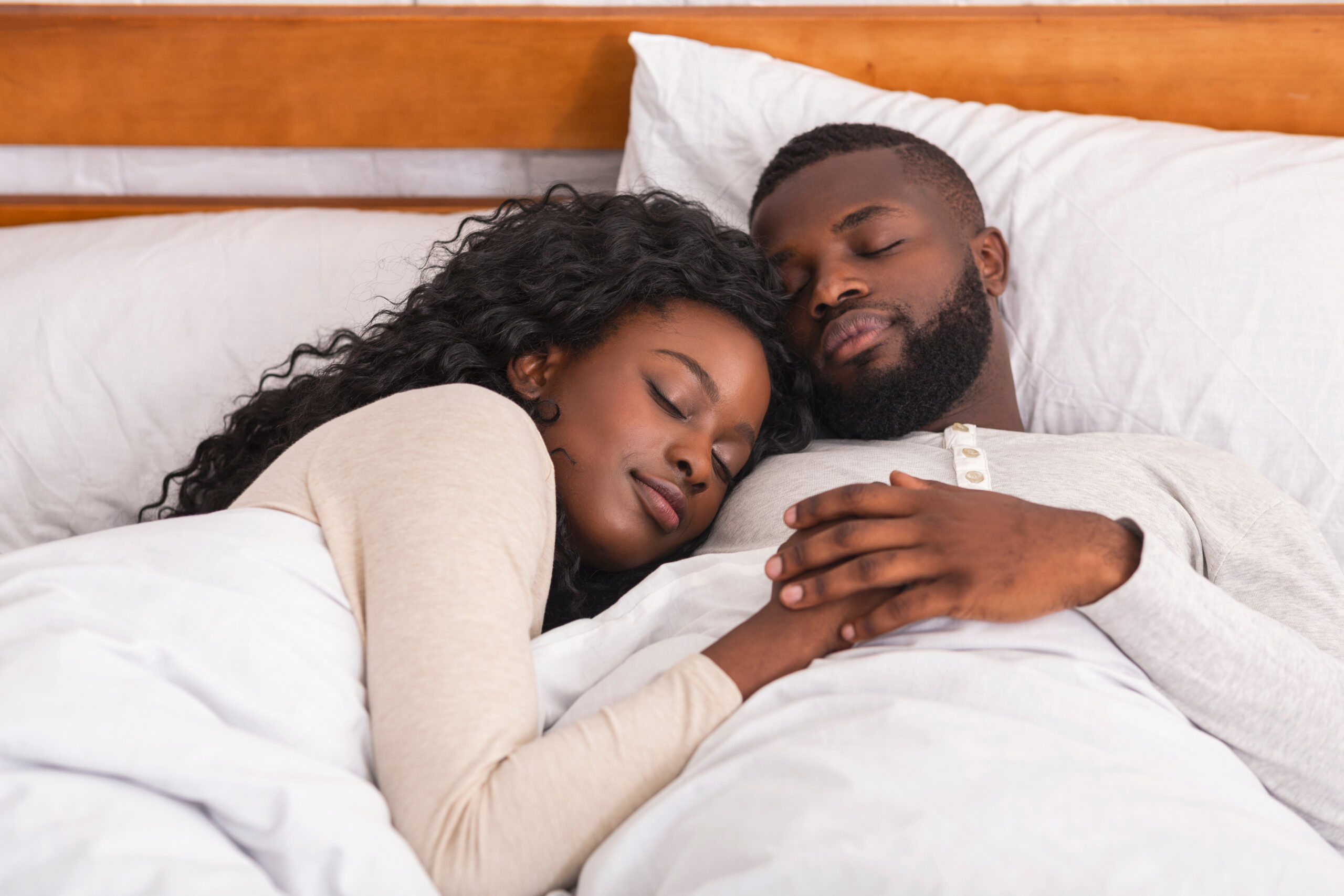 Afro couple sleeping in comfortable bed at home husband and wife in their room in their bed sleeping