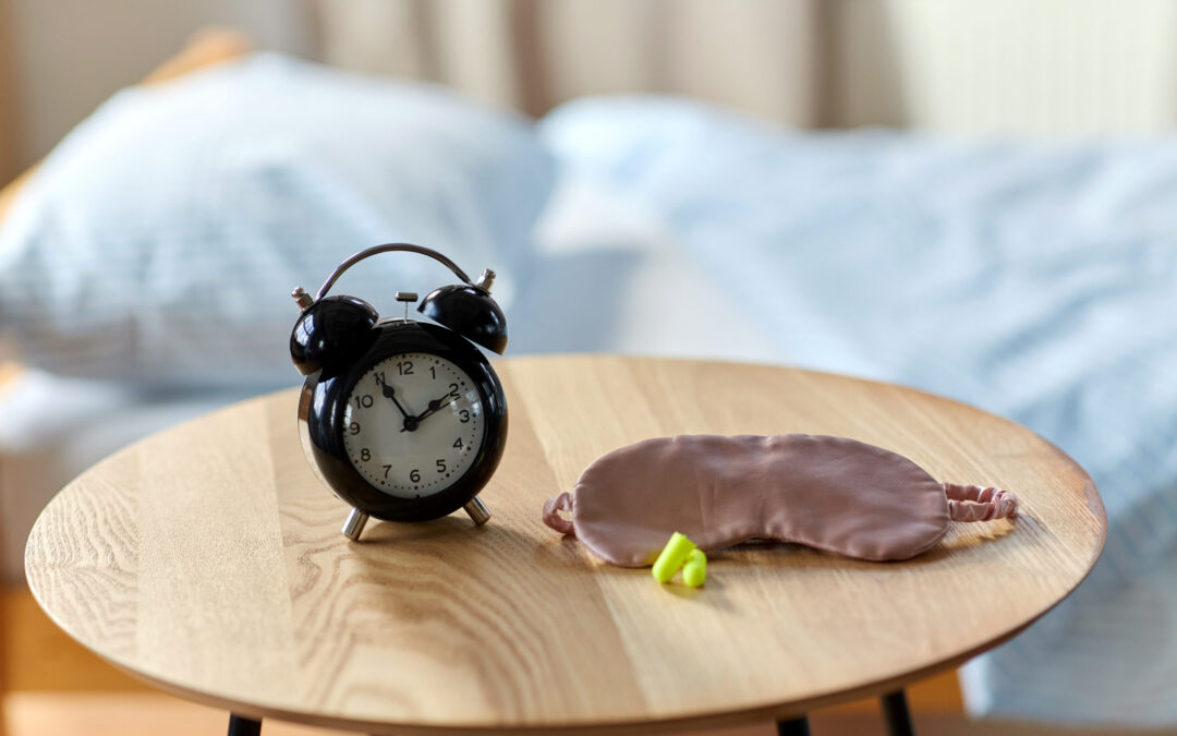 clock on the table with a sleep mask