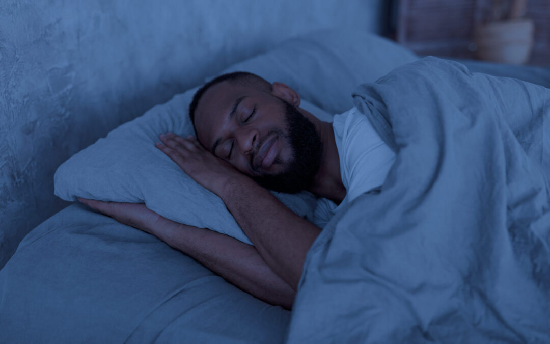 man sleeping soundly in his bed