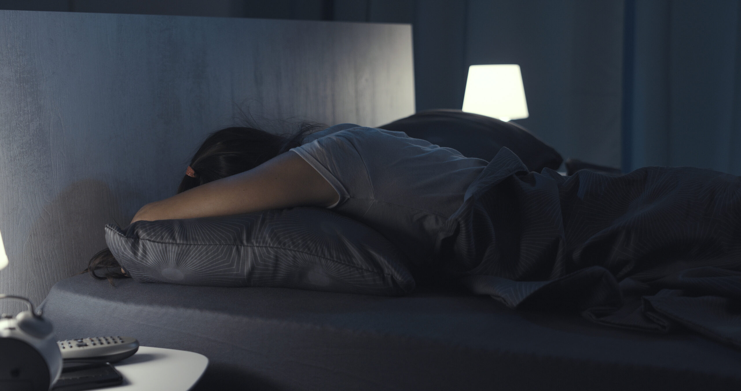 Woman sleeping in her bed at night man sleeping soundly in his bed