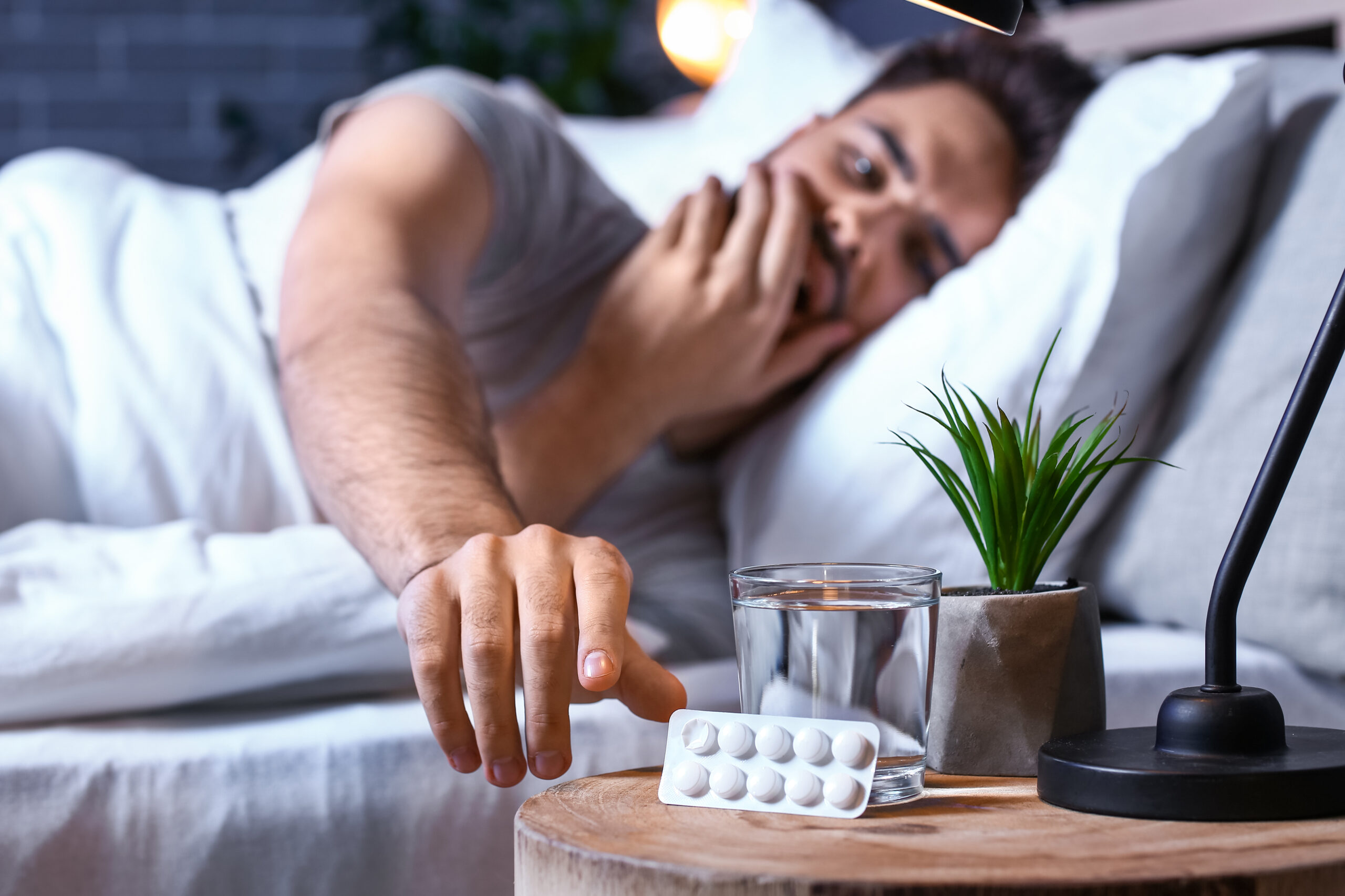 view of a man in his room taking sleeping pills