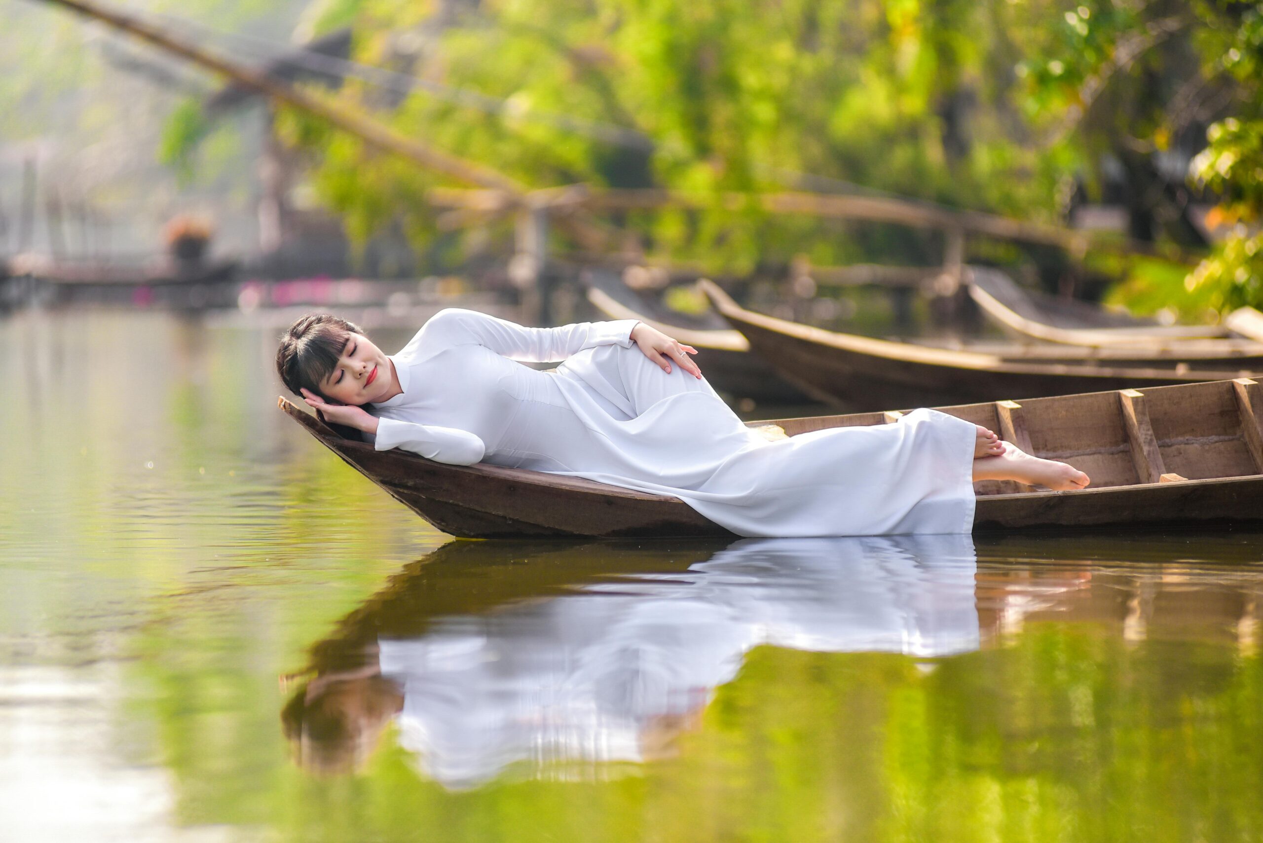 sleep-meditation_PhotoCredit_Sang Tran_pexels-sangtran98-7244591 Woman sleeping in a boat on the river after her meditation.